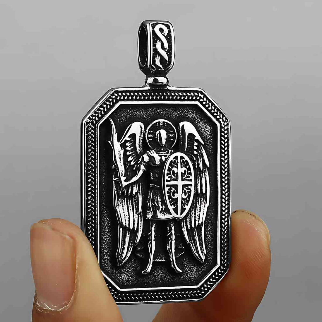 Saint Michael Medallion Pendant Necklace Displayed on Rocks Xenos Jewelry